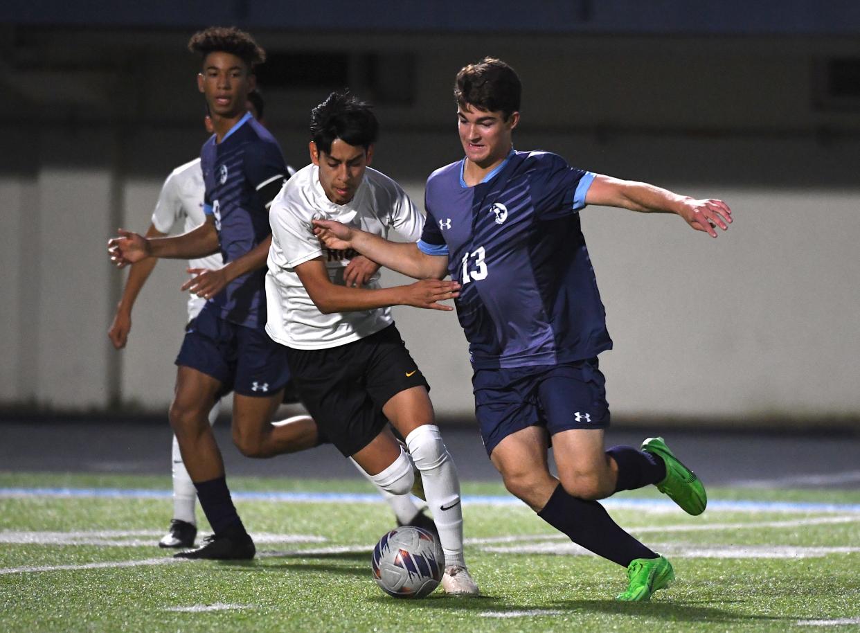 Bartlesville High School's Austin Bastings (13) fights for control of the ball during soccer action in Bartlesville earlier in the season.