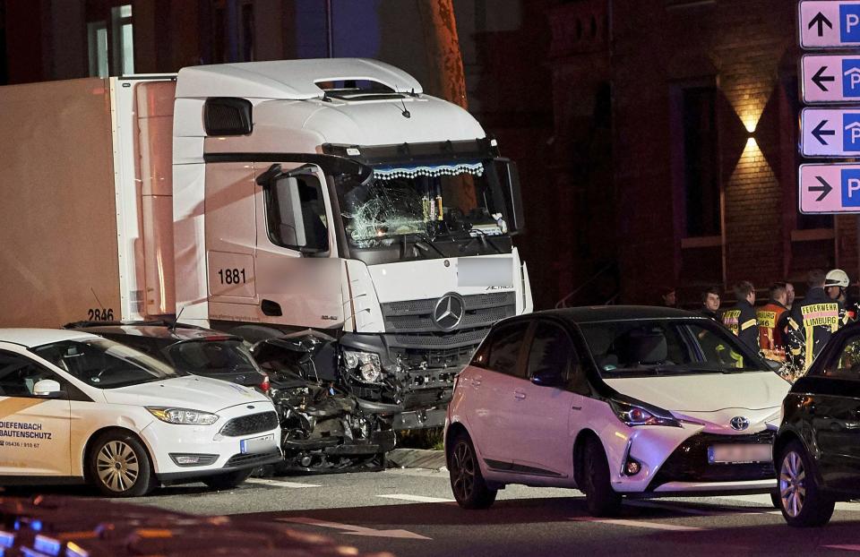 In this Monday, Oct. 7, 2019 photo s truck stands between damaged cars in Limburg, Germany. The truck drove into a line of eight cars in Limburg late Monday afternoon, pushing the vehicles into each other. Police said seven people were taken to hospitals and the driver also was slightly injured. He was detained. (Sascha Ditscher/dpa via AP)