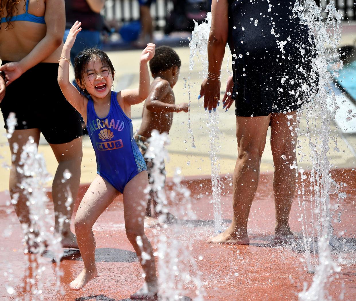 With temperatures soaring into the 80s, the city's pools, spray parks and beaches opened at just the right time, Friday including the Crompton Park Pool where Baylee Quach, 5, revels in the fountain water.