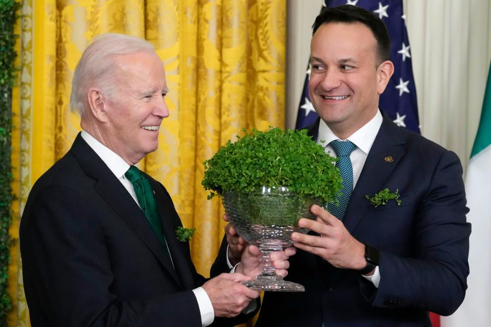 President Joe Biden and Ireland's Taoiseach Leo Varadkar hold a bowl of shamrocks during a St. Patrick's Day reception in the East Room of the White House on March 17.