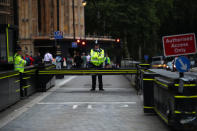 Police officers stand at the vehicle barrier to the Houses of Parliament where a car crashed after knocking down cyclists and pedestrians yesterday in Westminster, London, Britain, August 15, 2018. REUTERS/Hannah McKay