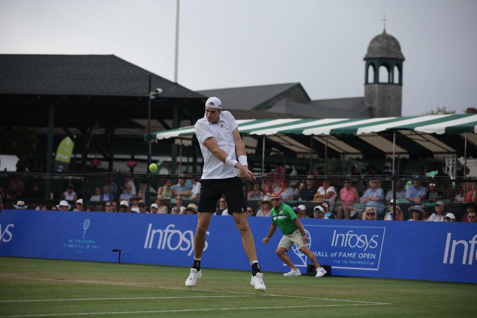 John Isner returns a shot to No. 1 seed Tommy Paul on Friday at the Infosys Hall of Fame Open.