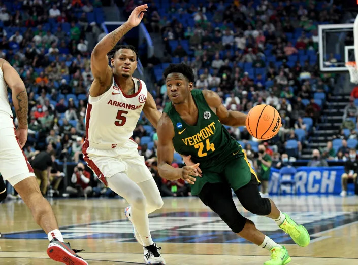 Vermont Catamounts guard Ben Shungu (24) dribbles past Arkansas Razorbacks guard Au&#39;Diese Toney (5) in the first half during the first round of the 2022 NCAA Tournament at KeyBank Center.