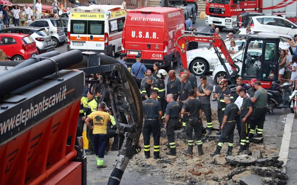 A digger gouged a huge hole in the road to allow around 30 firefighters and other specialists to access the tiny tunnel - Shutterstock