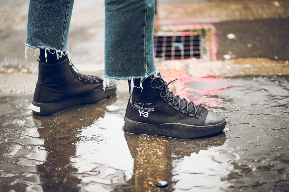 PARIS, FRANCE - JANUARY 21:  A guest wears Y-3 sneakers, under the rain, outside Paul Smith, during Paris Fashion Week - Menswear Fall Winter 2018-2019, on January 21, 2018 in Paris, France.  (Photo by Edward Berthelot/Getty Images)