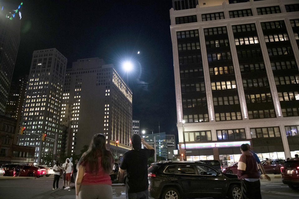 A helicopter circles as hundreds of people gather to protest over the death of George Floyd Friday, May 29, 2020, in Detroit. Floyd died in police custody Monday in Minneapolis. (Nicole Hester/Ann Arbor News via AP)