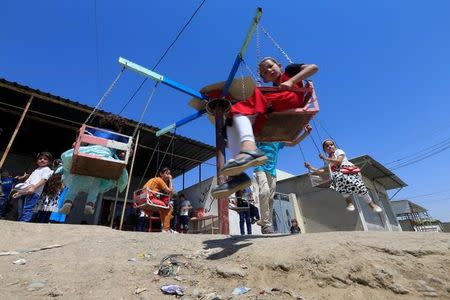 Iraqi children play as they celebrate Eid al-Fitr, in Mosul, Iraq June 25, 2017. REUTERS/Alaa Al-Marjani