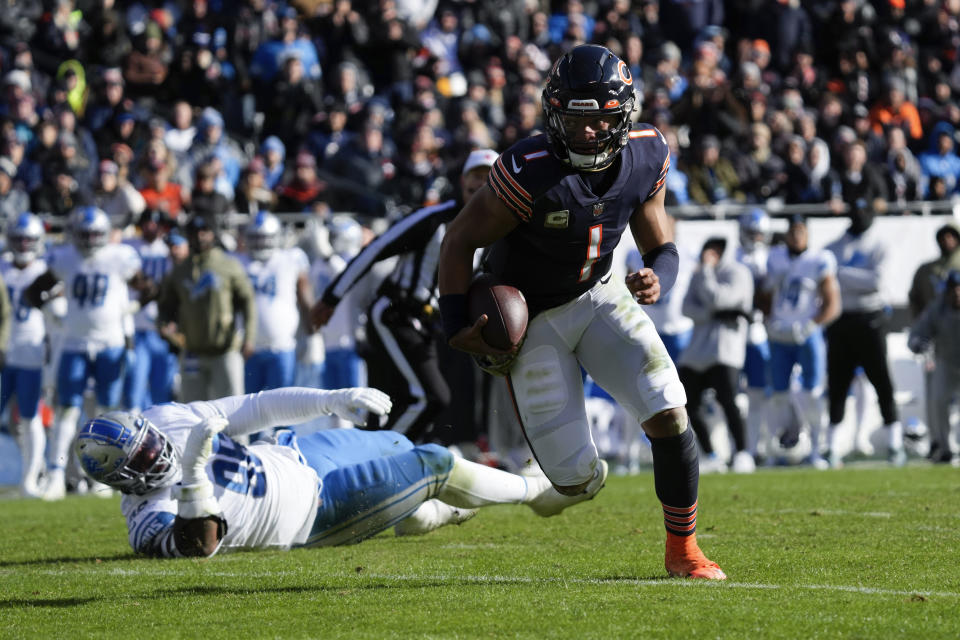 Chicago Bears quarterback Justin Fields (1) runs for a one-yard touchdown after escaping Detroit Lions defensive end Isaiah Buggs (96) during the first half of an NFL football game in Chicago, Sunday, Nov. 13, 2022. (AP Photo/Nam Y. Huh)