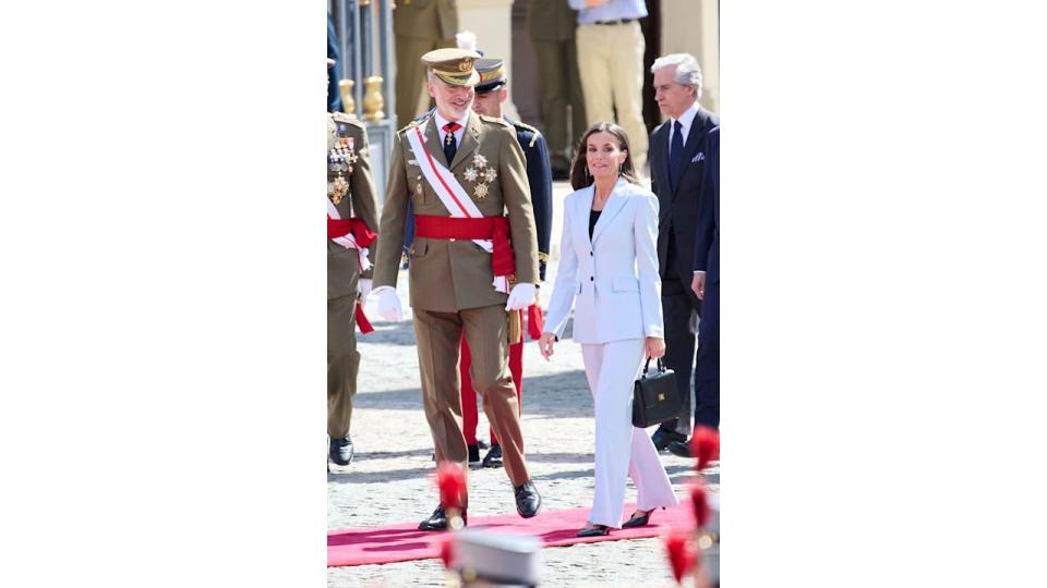 King Felipe in military uniform and Queen Letizia in blue suit
