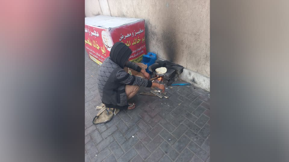 A displaced man makes bread next to a tent he set up on a sidewalk in Rafah, in southern Gaza, on January 22. - Courtesy Mohammed Hamouda