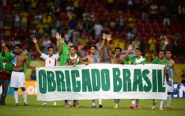 Tahiti players hold ‘thank you, Brazil’ banner after their final Confederations Cup match