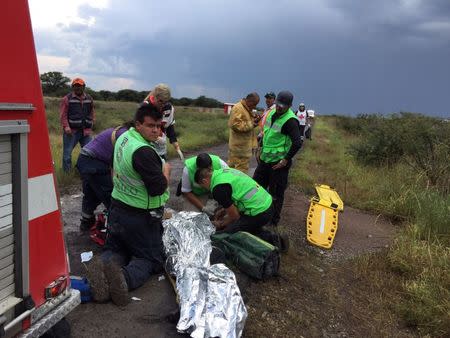 Paramedics attend to a victim near the site where an Aeromexico-operated Embraer passenger jet crashed in Mexico's northern state of Durango, July 31, 2018, in this picture obtained from social media. Proteccion Civil Durango/via REUTERS