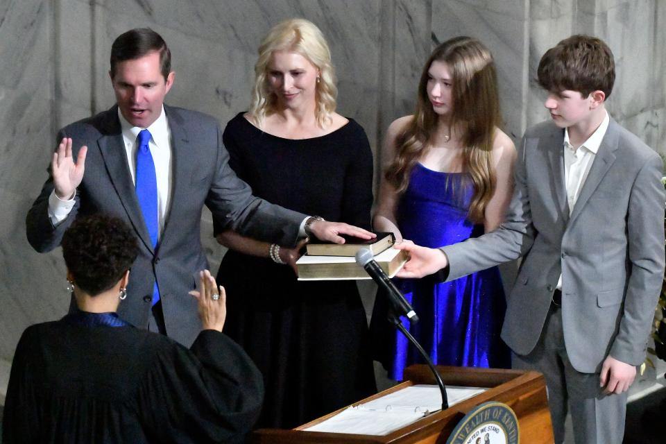 From left, Kentucky Governor Andy Beshear, his wife Britainy Beshear, his daughter Lila, and his son Will, stand by his side as he takes the oath of office from Kentucky Court of Appeals Judge Pamela Goodwine during the 62nd Inauguration of Governor in Frankfort, Ky., Tuesday, Dec. 12, 2023. (AP Photo/Timothy D. Easley)