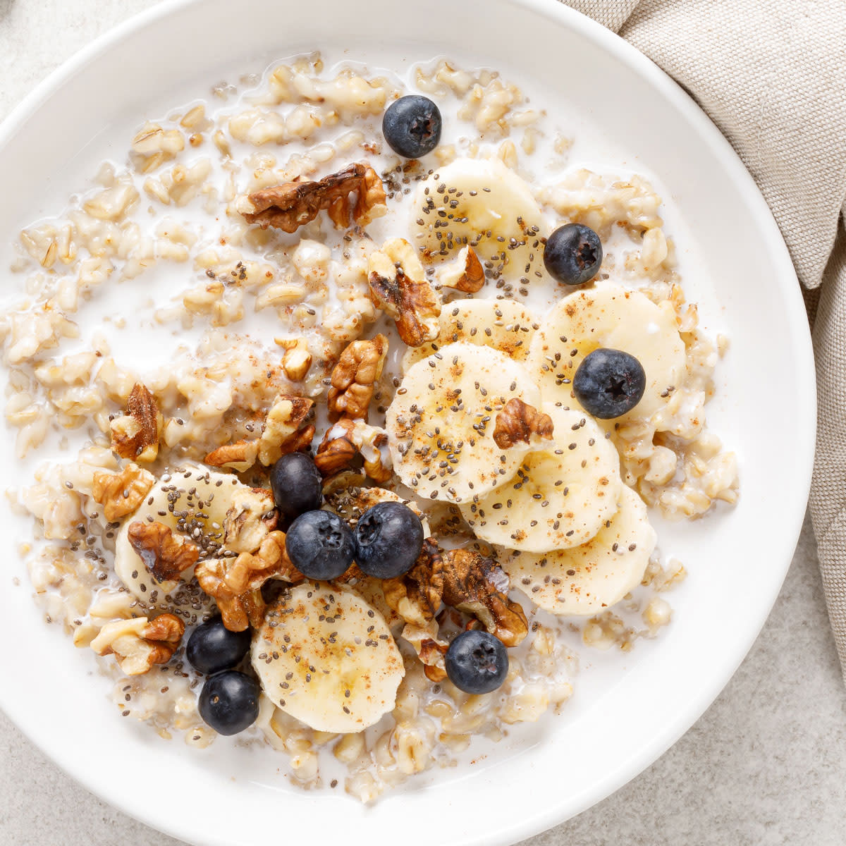 oatmeal topped with banana, blueberries, and walnuts