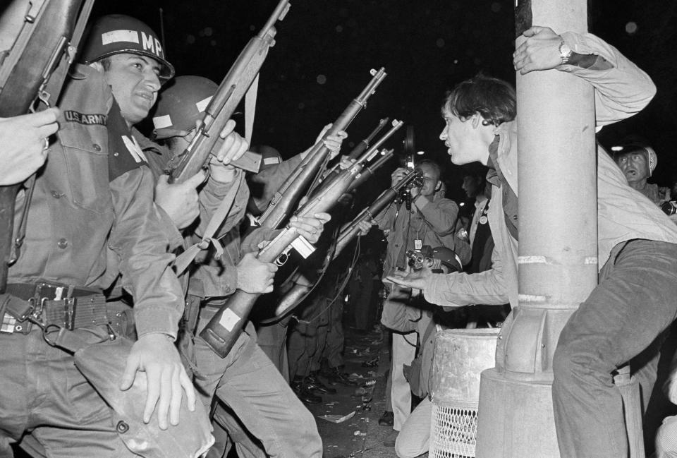 FILE - Chicago police officers attempt to disperse demonstrators outside the Conrad Hilton, Democratic Convention headquarters hotel, August 29, 1968. As pro-Palestinian demonstrations escalate on college campuses around the country, critics of President Joe Biden’s handling of the Israel-Hamas war suggest this summer’s Democratic National Convention could be marred by protests and scenes of chaos that undermine his reelection. It raises the specter of a replay of 1968’s Democratic convention in Chicago, where a violent police crackdown created indelible scenes of chaos. (AP Photo/RHS, File)