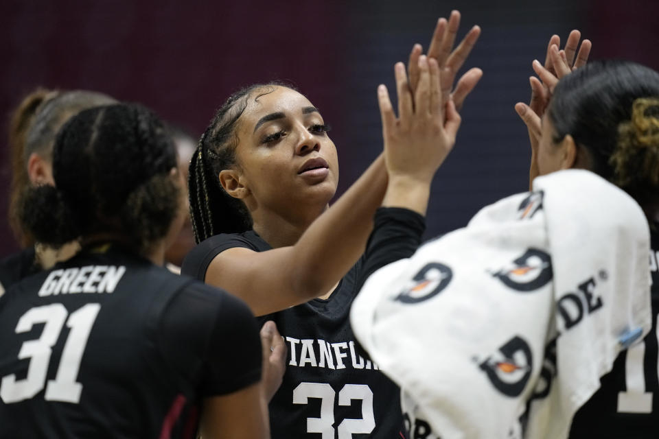 Stanford guard Jzaniya Harriel, center, celebrates with teammates during a timeout in the second half of an NCAA college basketball game against San Diego State, Friday, Dec. 1, 2023, in San Diego. (AP Photo/Gregory Bull)