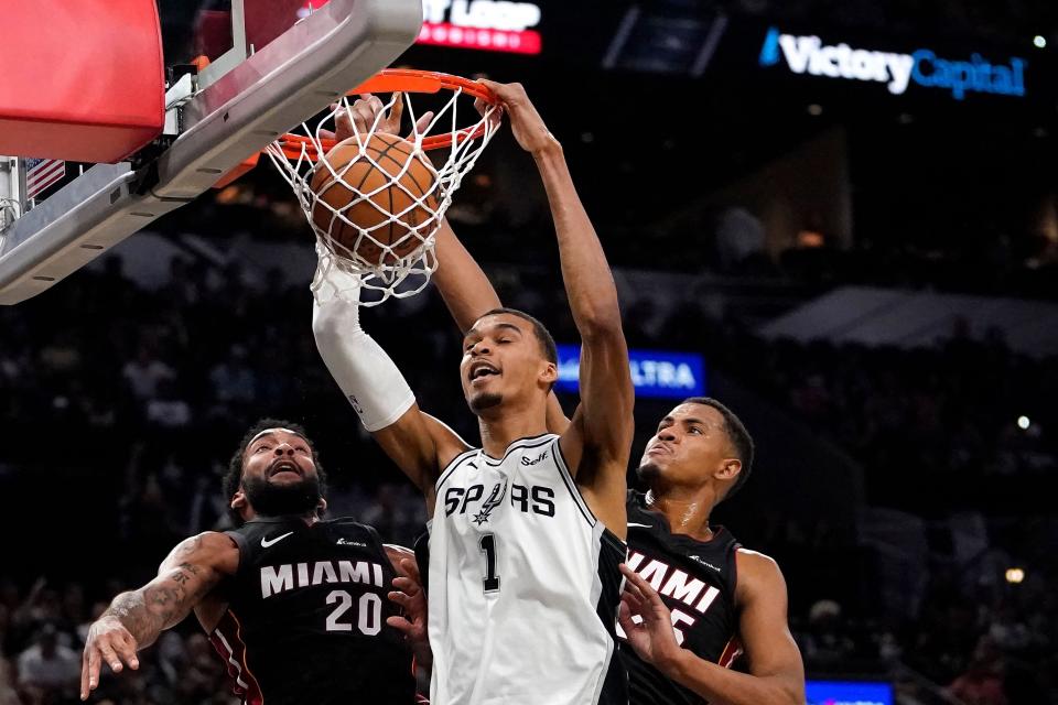 San Antonio Spurs' French forward #01 Victor Wembanyama (C) scores during the NBA preseason game between the San Antonio Spurs and Miami Heat at the AT&T Center in San Antonio, Texas, on October 13, 2023.