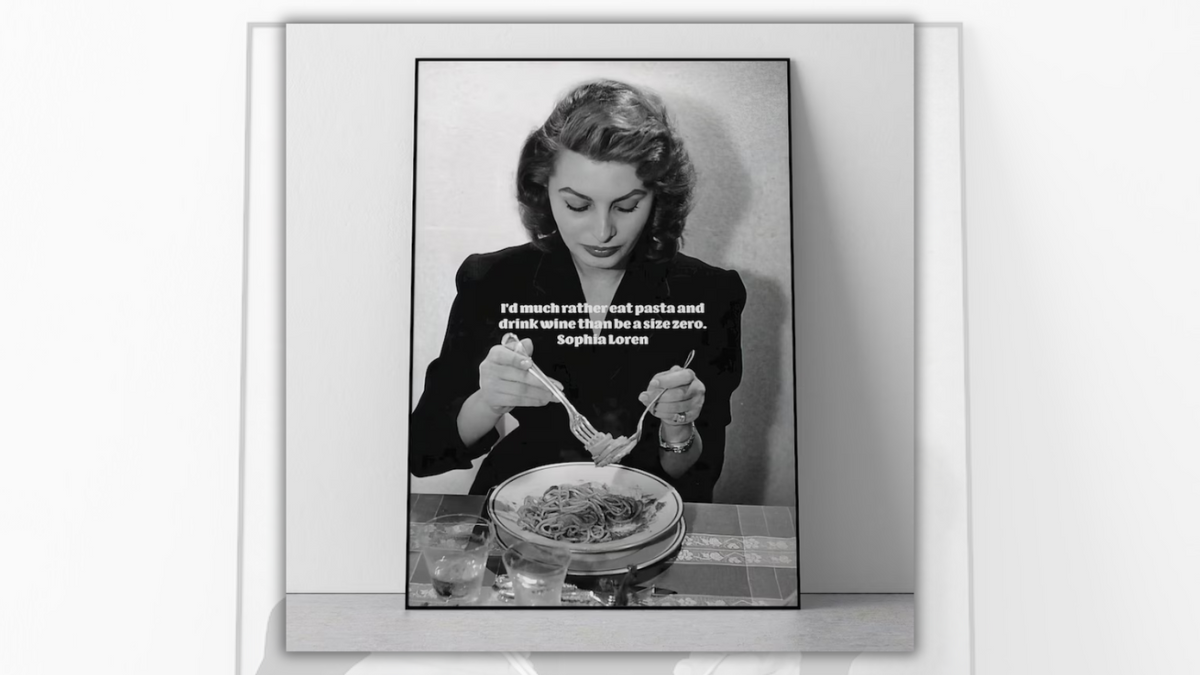 A black and white image shows a white woman eating pasta. On the image, white text says, "I