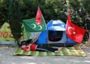 A Turkish man protesting against the military coup rests near his tent in a public garden in Ankara, on July 25, 2016