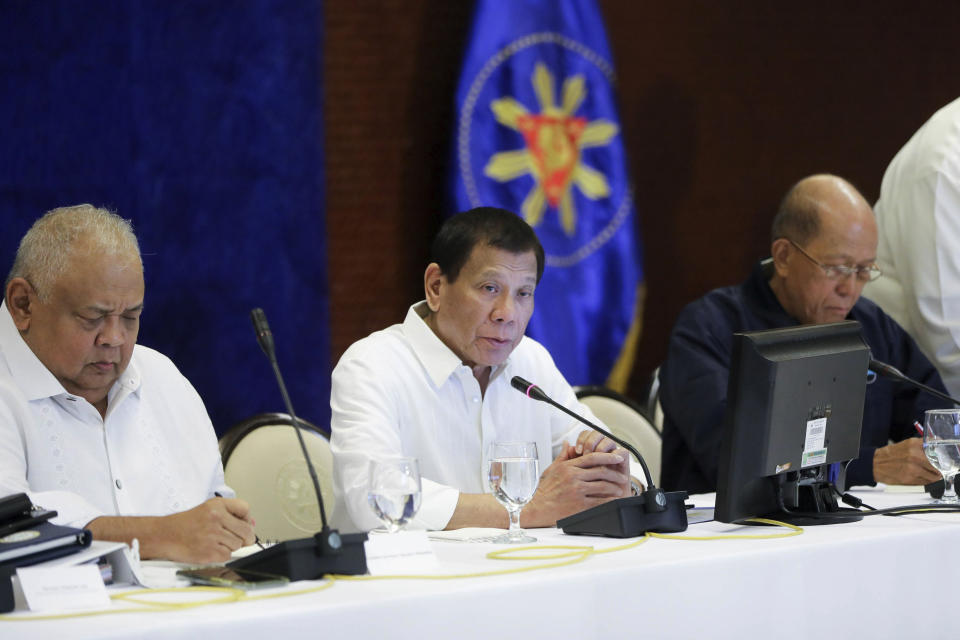 In this Jan. 7, 2020, photo provided by the Malacanang Presidential Photographers Division, Philippine President Rodrigo Duterte, center, talks during the Joint Armed Forces of the Philippines-Philippine National Police (AFP-PNP) Command Conference at the Malacanang presidential palace in Manila, Philippines. The Philippine government has ordered the mandatory evacuation of Filipino workers from Iraq and is sending a coast guard vessel to the Middle East to rapidly ferry its citizens to safety in case hostilities between the United States and Iran worsen, officials said Wednesday. (Alfred Frias/ Malacanang Presidential Photographers Division via AP)