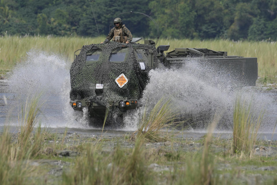 American Marines ride their vehicle across a stream during annual combat drills between the Philippine Marine Corps and U.S. Marine Corps in Capas, Tarlac province, northern Philippines, Thursday, Oct. 13, 2022. Truck-mounted launchers blasted off rockets Thursday and U.S. stealth fighter jets streaked across the northern Philippine sky in a combat drill and latest display of American firepower in a region where Washington has tried to deter what it warns as China's growing aggression. (AP Photo/Aaron Favila)