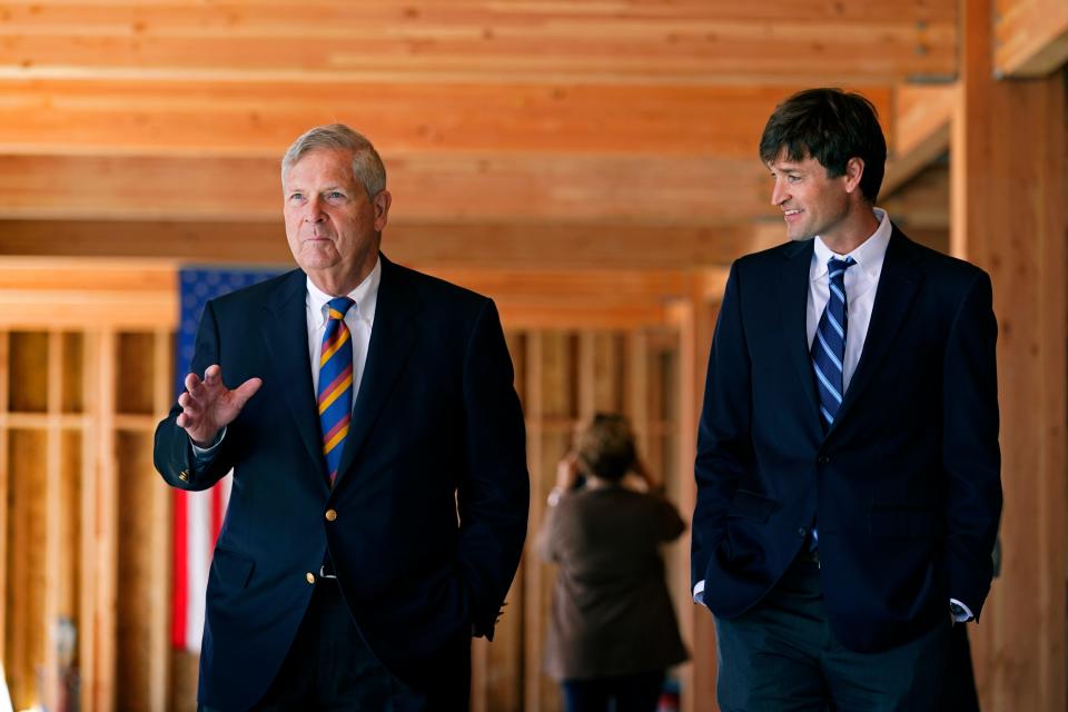 Agriculture Secretary Tom Vilsack talks with developer Scott Cutler, right, as he tours a mass timber project in West Des Moines' Valley Junction on Friday.