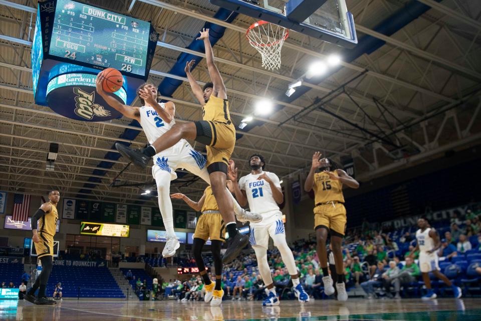 Florida Gulf Coast Eagles guard Caleb Catto (2) shoots over Purdue Fort Wayne Mastodons forward Johnathan DeJurnett (5) during the first half of the Hilton Garden Inn FGCU Invitational between the Purdue Fort Wayne Mastodons and the Florida Gulf Coast Eagles, Sunday, Nov. 28, 2021, at Alico Arena in Fort Myers, Fla.FGCU led Purdue Fort Wayne 34-32 at halftime.