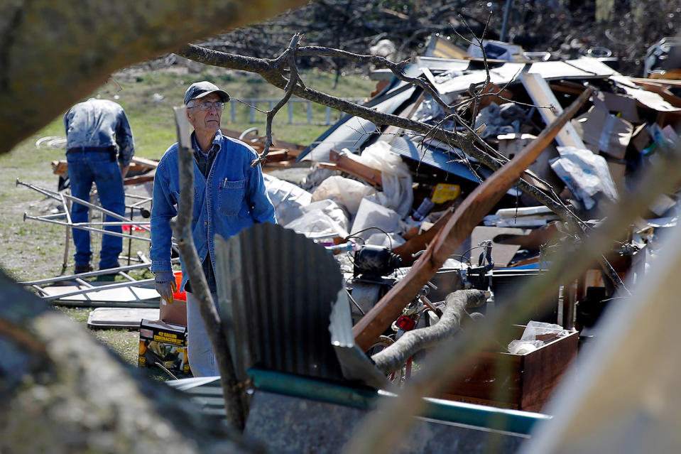 Man looking over damage to property
