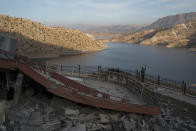 <p>A man takes a picture on the rubble of a destroyed structure near Darbandikhan Lake after an earthquake, in the city of Darbandikhan, northern Iraq, ov. 13, 2017. A powerful 7.3 magnitude earthquake near the Iraq-Iran border has killed over 350 people across both countries, sent residents fleeing their homes into the night and was felt as far away as the Mediterranean coast. (Photo: Felipe Dana/AP) </p>