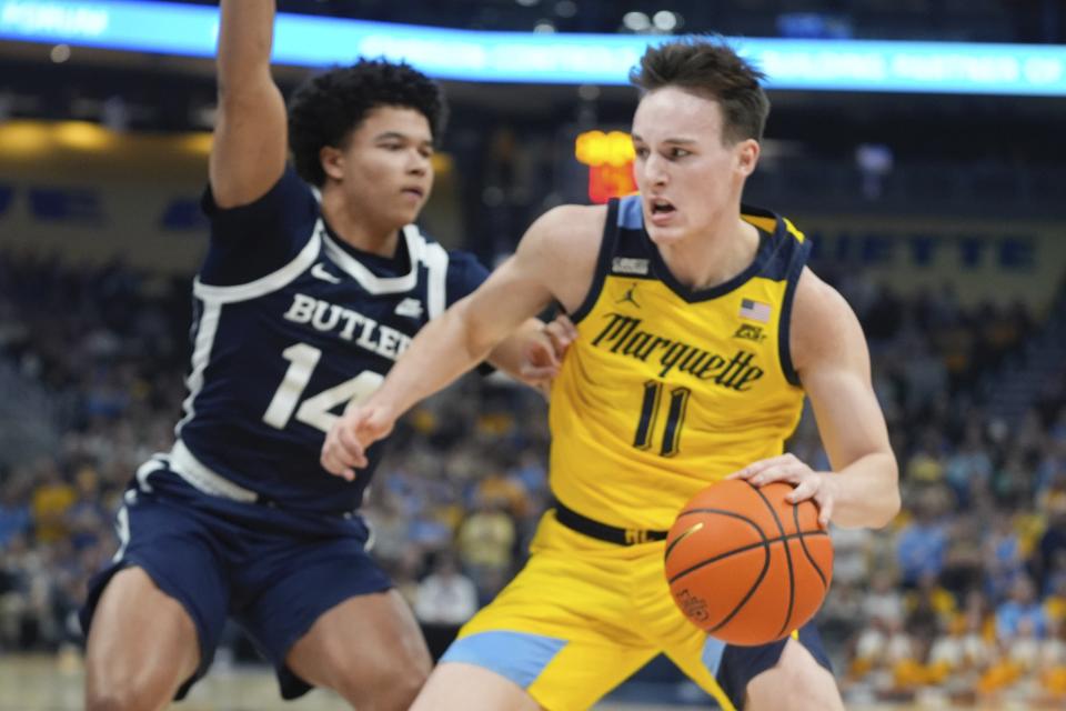 Marquette's Tyler Kolek tries to get past Butler's Landon Moore during the first half of an NCAA college basketball game Wednesday, Jan. 10, 2024, in Milwaukee. (AP Photo/Morry Gash)