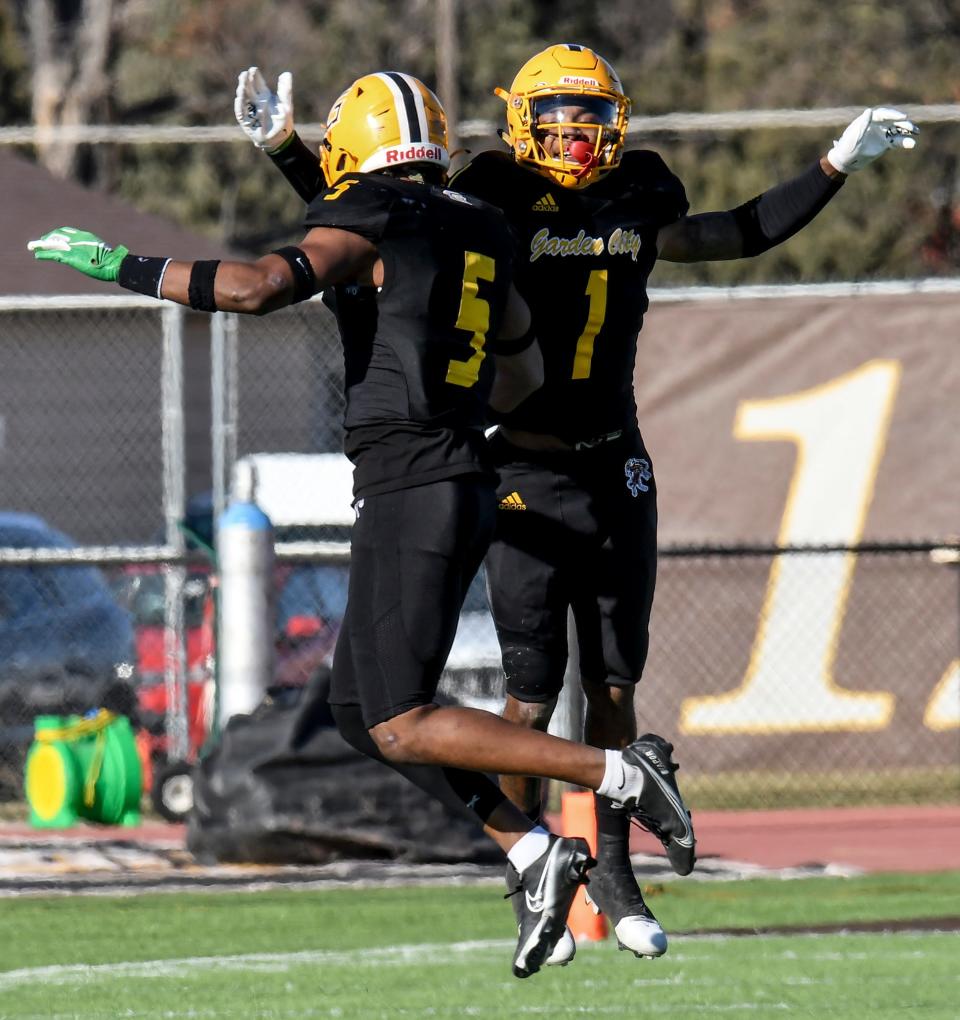 Garden City Community College defensive backs Keylon Kennedy, right, and Chris Smith celebrate making a third-and-short stop for a change of possession Saturday against Navarro in the Scooter's Coffee Bowl at Broncbuster Stadium.  Kennedy has been named the Jayhawk Conference defensive player of the year.