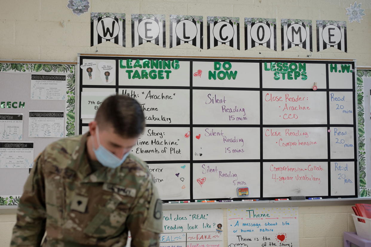 National Guard Specialist Austin Alt fills in as a substitute due to a teacher shortage caused by COVID and other non-illness related absences in Pojoaque, New Mexico, January 28, 2022. REUTERS/Adria Malcolm