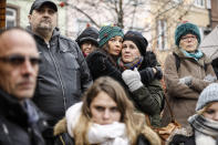 Residents react during a gathering being held in a central square of the eastern French city of Strasbourg, Sunday Dec.16, 2018 to pay homage to the victims of a gunman who killed four people and wounded a dozen more. The gathering was held in Kleber Square by a Christmas market and near where the gunman opened fire last Tuesday evening. (AP Photo/Jean-Francois Badias)