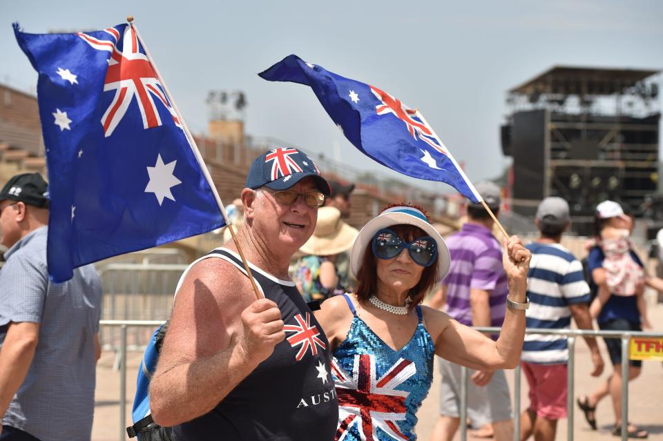 People wave the country's flag to celebrate Australia Day in Sydney.