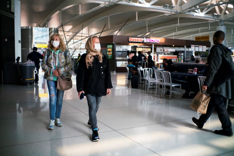 People walk around terminal one at JFK airport after the Federal Aviation Administration (FAA) temporarily halted flights arriving at New York City airports due to coronavirus disease (COVID-19) in New York