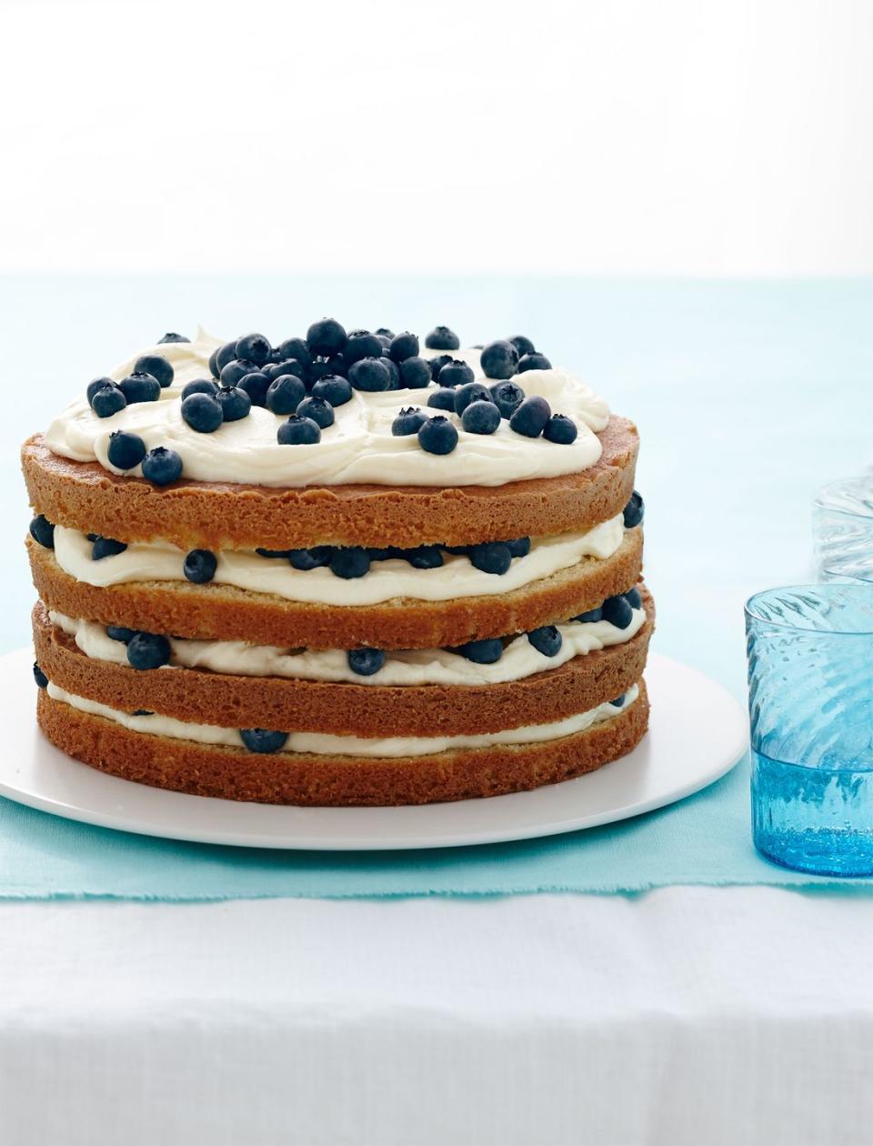 <p>The sides of the cake are left unfrosted so you can see the beautiful layers of cream, lemon, and blueberries. </p><p>Get the <strong><a href="https://www.womansday.com/food-recipes/food-drinks/recipes/a13417/lemon-blueberry-layer-cake-recipe-wdy0414/" rel="nofollow noopener" target="_blank" data-ylk="slk:Lemon Blueberry Layer Cake recipe.;elm:context_link;itc:0;sec:content-canvas" class="link ">Lemon Blueberry Layer Cake recipe. </a></strong></p>