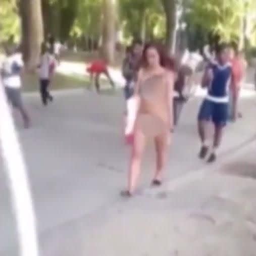 A woman walks through a park in Italy completely naked.