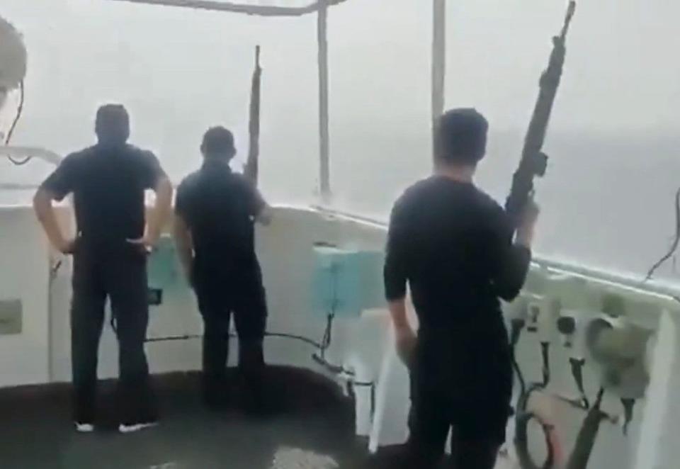 Security crew about the M/V <em>Tutor</em> watch the Houthi USV approach the ship.