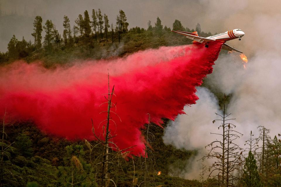 An air tanker drops retardant while battling the Ferguson fire in Stanislaus National Forest, near Yosemite National Park, California on July 21, 2018.