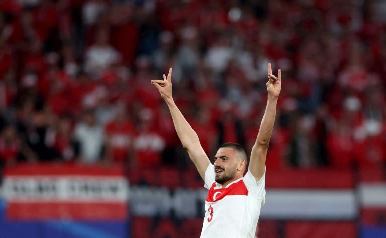 Turkey's defender #03 Merih Demiral makes a controversial hand gesture as he celebrates scoring his team's second goal during the UEFA Euro 2024 round of 16 football match between Austria and Turkey at the Leipzig Stadium in Leipzig on July 2, 2024. UEFA said on July 3, 2024 it had opened a probe into Turkey defender Merih Demiral for celebrating a goal in the team's 2-1 win against Austria at Euro 2024 with an allegedly ultra-nationalist salute. The tournament organiser said in a statement it was investigating the player for "inappropriate behaviour" during the knockout game in Leipzig. The gesture, which Demiral made to the crowd after scoring his second goal of the game, is associated with Turkish ultra-nationalist group Grey Wolves. (Ronny HARTMANN)