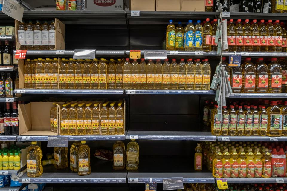 A supermarket shelf in Spain is seen half stocked with sunflower oil.