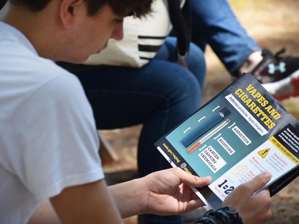 Diman student Aidan Farias reads about vaping at the Teen Safety Summit held at Camp Welch this past spring.