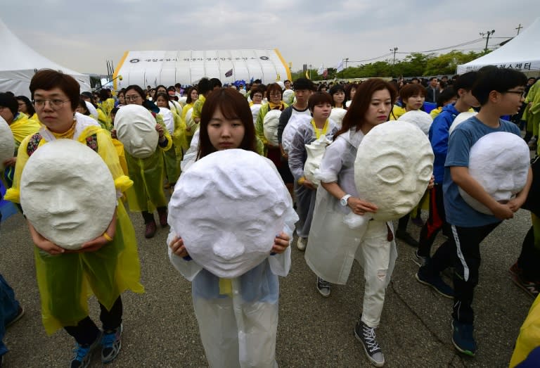 Mourners march with paper mache figures representing the 304 victims of South Korea's Sewol ferry disaster during the 2nd anniversary memorial event, in Ansan, the victims' home city, on April 16, 2016