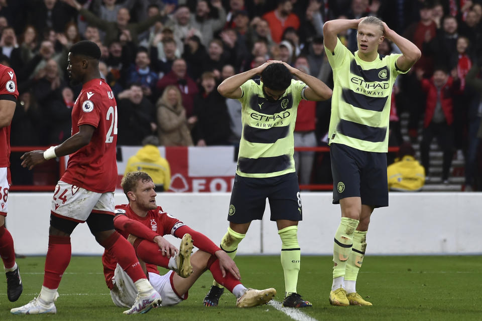 Manchester City's Ilkay Gundogan, second right, and Manchester City's Erling Haaland, right, react after missing a scoring chance during the English Premier League soccer match between Nottingham Forest and Manchester City at City ground in Nottingham, England, Saturday, Feb. 18, 2023. (AP Photo/Rui Vieira)