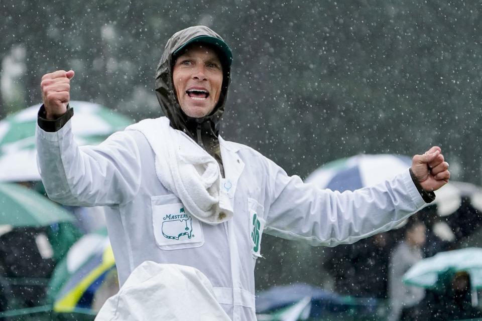 FILE - Apr 8, 2023; Augusta, Georgia, USA; Keith Mitchell's caddie, John Limanti, chants "let us play" as heavy rain falls at the 18th green during the third round of The Masters golf tournament. Mandatory Credit: Danielle Parhizkaran-USA TODAY Network