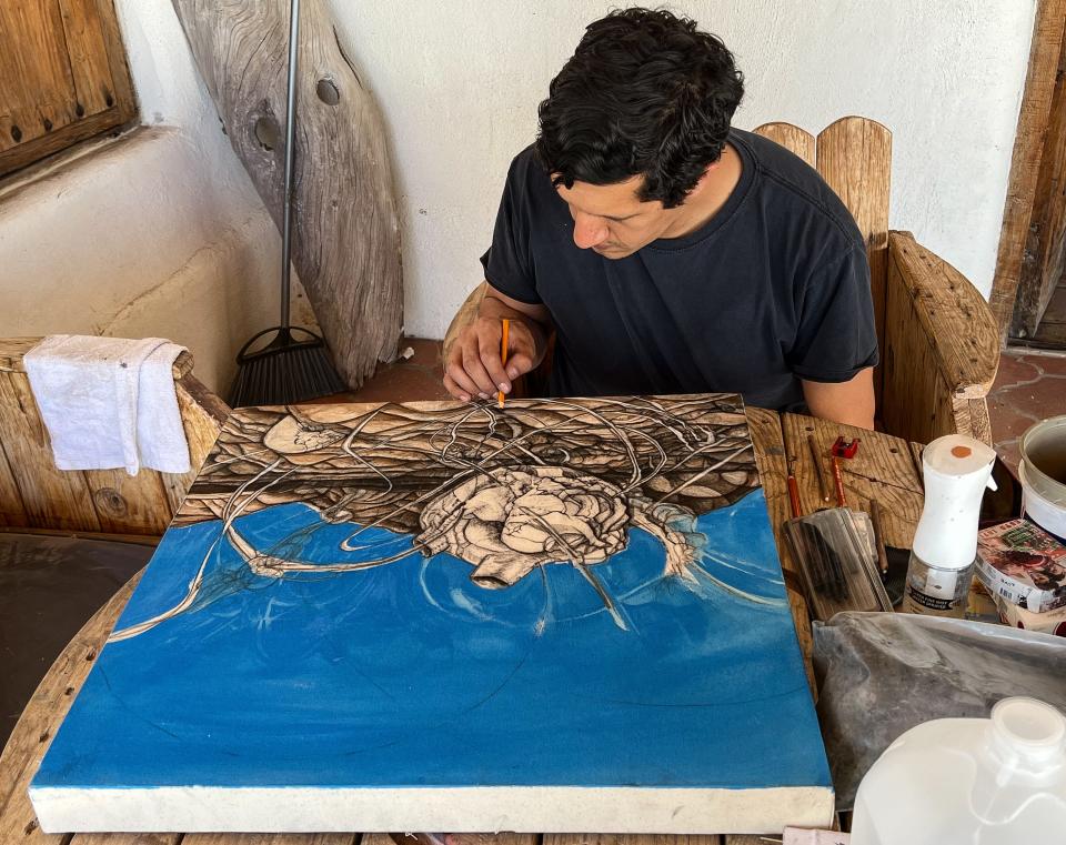 El Paso artist Efrén Solórzano works on a piece for his exhibit, "A.M.O.K. + Retrospectiva," which will run through June 2022 at Casa Ortiz.