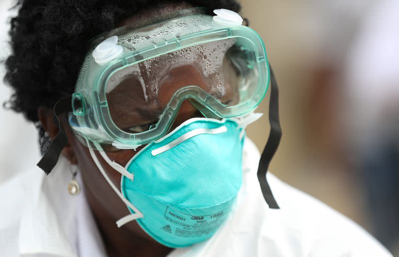 A member of medical staff looks on as they test residents