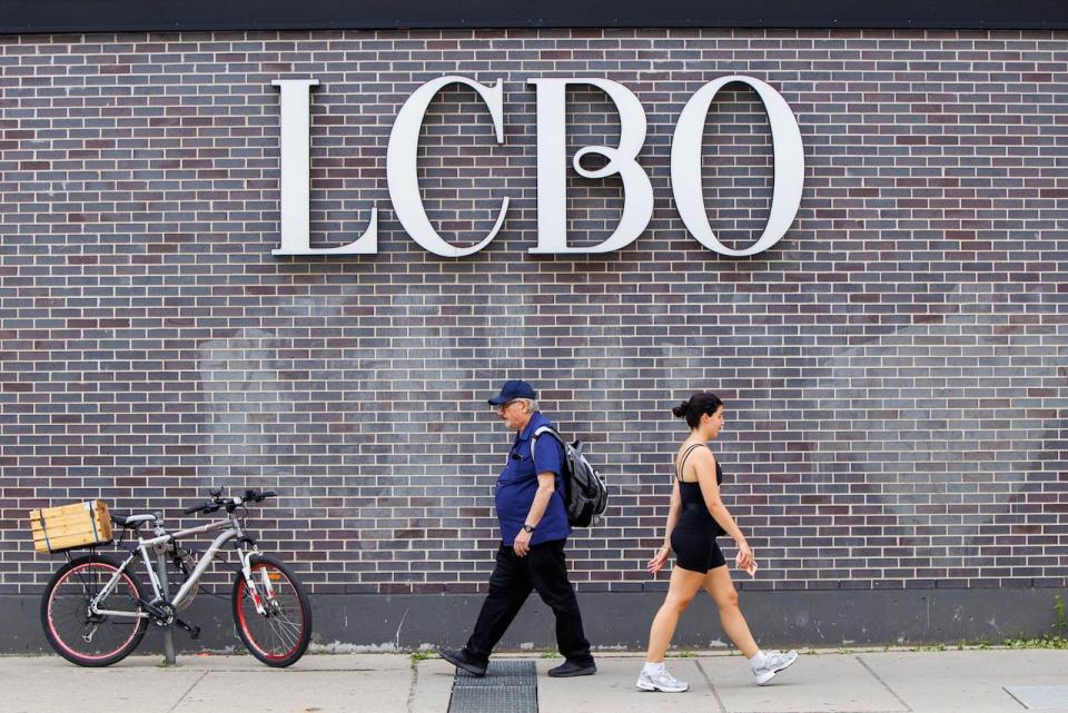 People walk past a Toronto LCBO location on July 4, 2024.