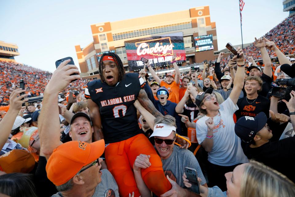 OSU running back Ollie Gordon II (0) celebrates with fans after a 27-24 win against OU in Bedlam on Saturday at Boone Pickens Stadium in Stillwater.