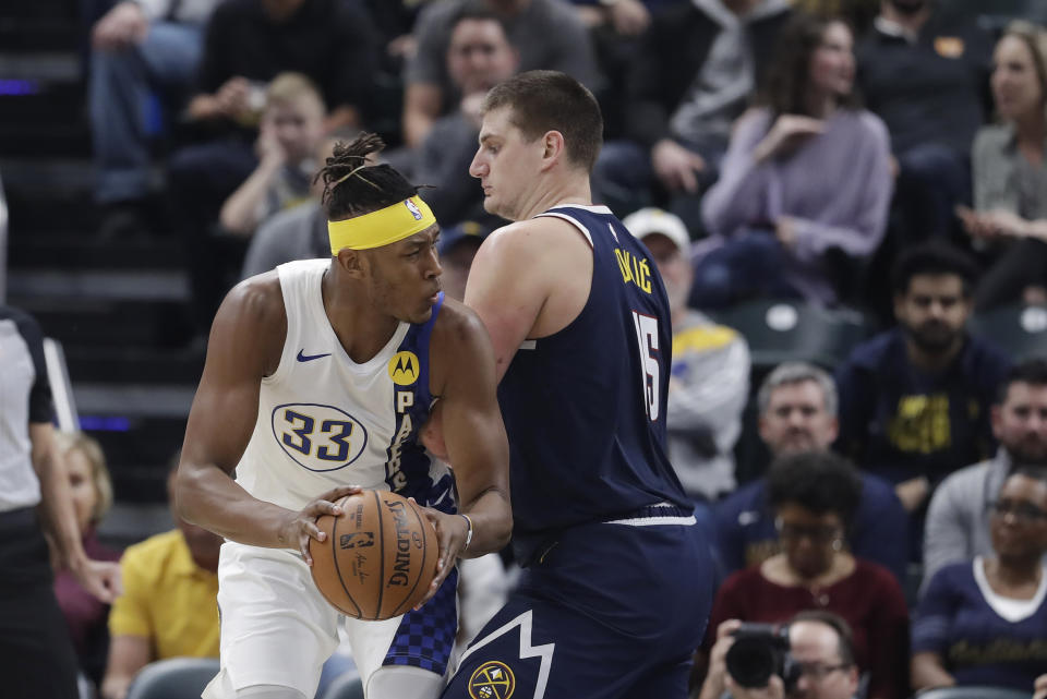 Indiana Pacers' Myles Turner (33) goes to the basket against Denver Nuggets' Nikola Jokic (15) during the first half of an NBA basketball game Thursday, Jan. 2, 2020, in Indianapolis. (AP Photo/Darron Cummings)